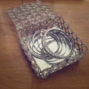 6 shiny bracelets inside jewelry box with mirror